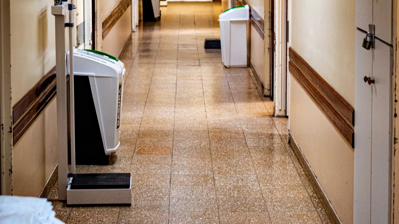 An empty, brightly lit hospital corridor